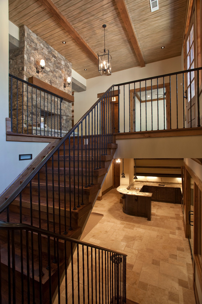 Mid-sized country wood u-shaped staircase in Atlanta with wood risers and metal railing.