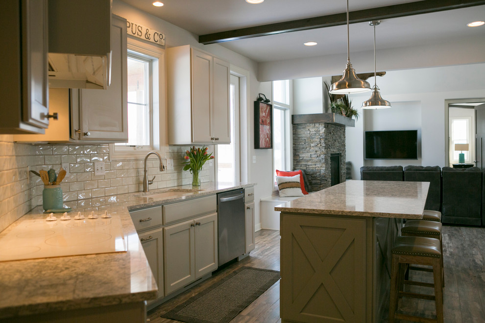 Open concept kitchen - mid-sized rustic l-shaped open concept kitchen idea with raised-panel cabinets, white cabinets, granite countertops, white backsplash, subway tile backsplash, stainless steel appliances, an island and gray countertops