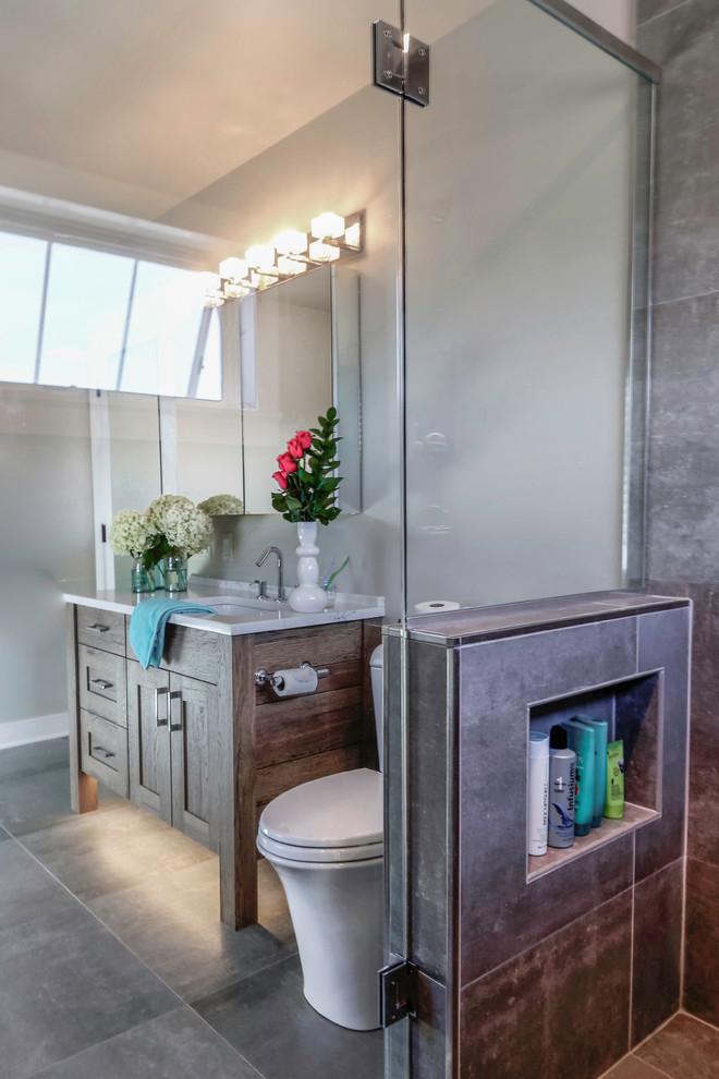Alcove shower - transitional master cement tile alcove shower idea with shaker cabinets, medium tone wood cabinets, a one-piece toilet, white walls, an undermount sink, quartz countertops and a hinged shower door