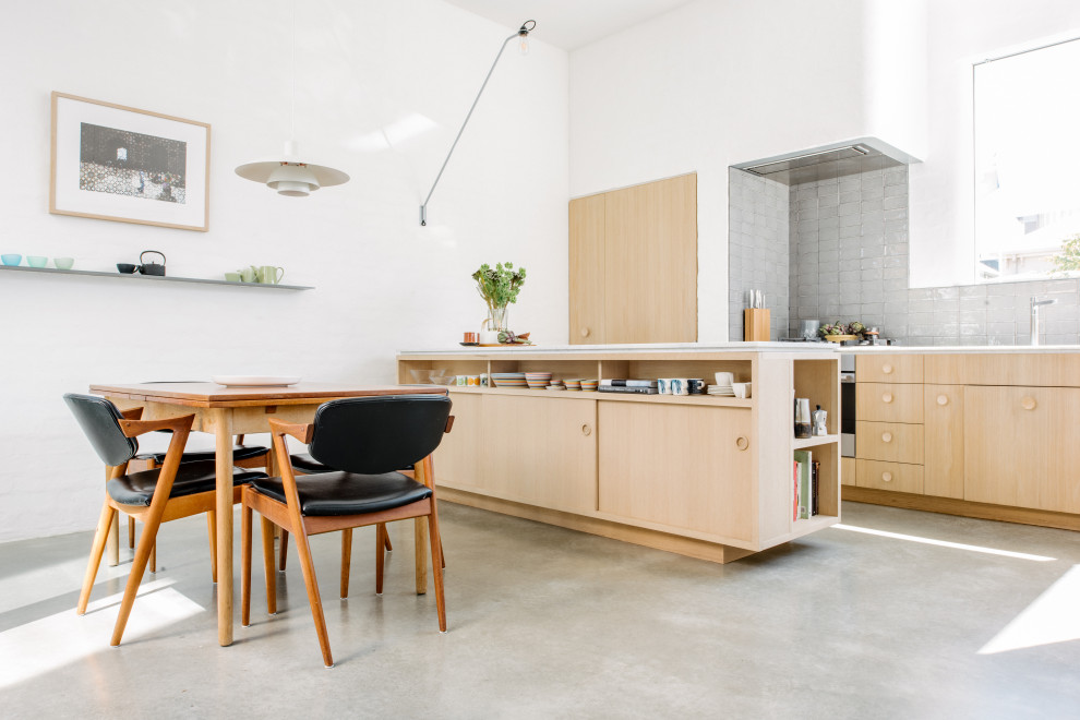 Photo of a scandinavian u-shaped eat-in kitchen in Melbourne with stainless steel appliances.