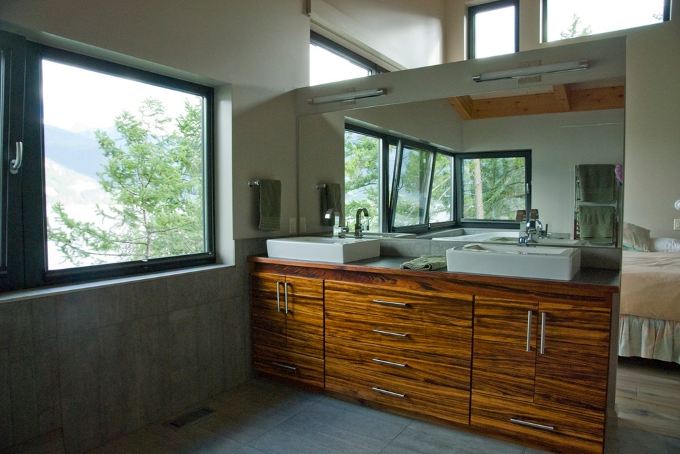 Mid-sized contemporary master bathroom in Other with a vessel sink, flat-panel cabinets, medium wood cabinets, laminate benchtops, a corner tub, a corner shower, gray tile, cement tile, white walls and ceramic floors.