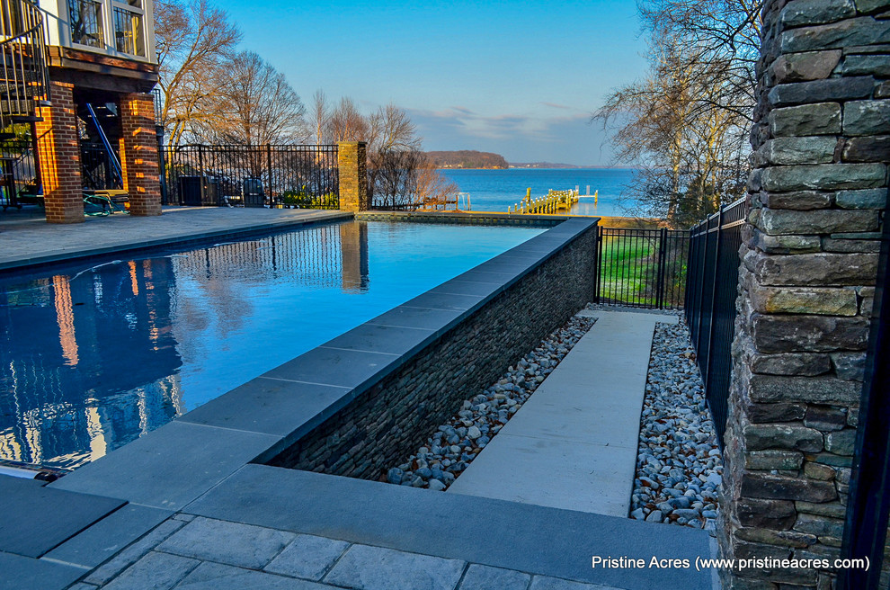 Mid-sized side yard concrete paver and rectangular lap pool photo in DC Metro