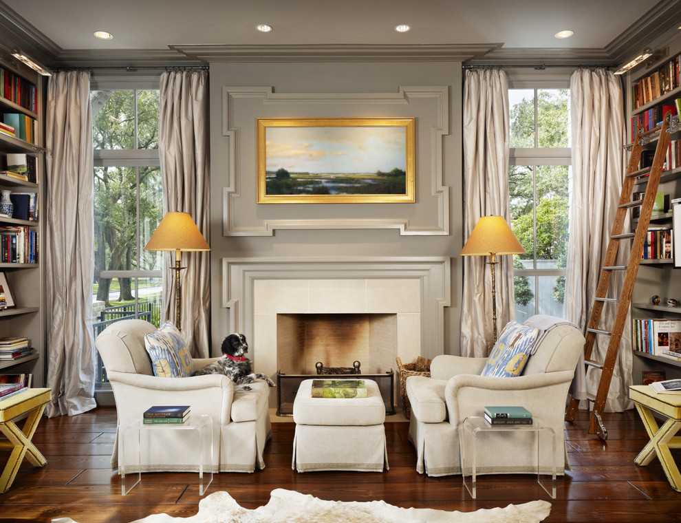 Inspiration for a mid-sized traditional living room in Houston with a library, grey walls, dark hardwood floors, a standard fireplace and a tile fireplace surround.