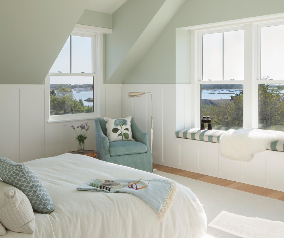 Design ideas for a beach style bedroom in Providence with green walls, light hardwood floors and brown floor.