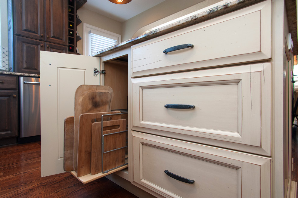 Photo of a country kitchen in Denver with flat-panel cabinets and white cabinets.