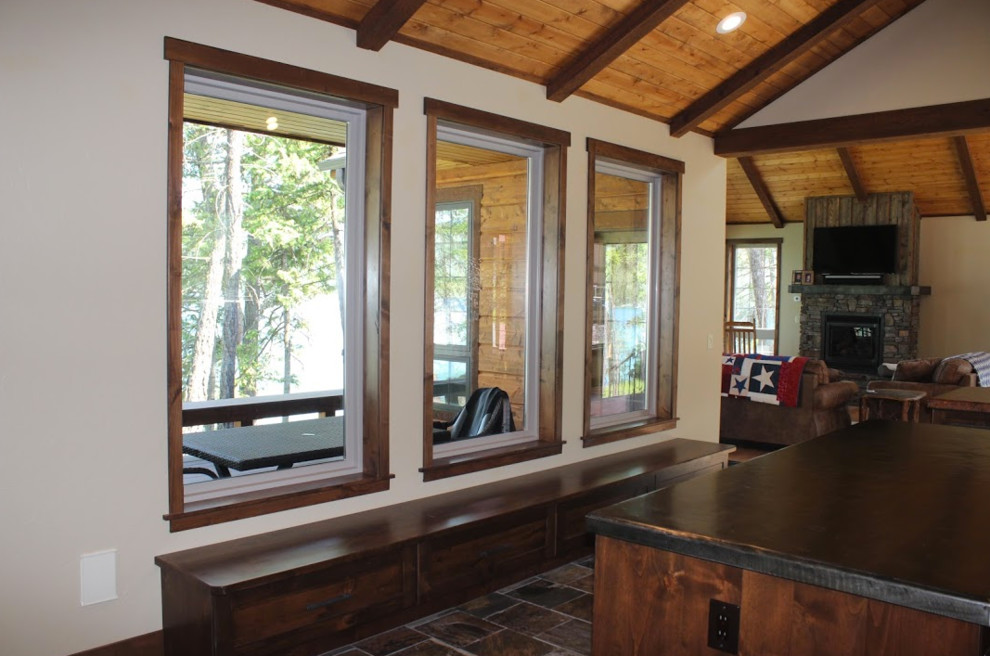 Eat-in kitchen - mid-sized transitional l-shaped medium tone wood floor and brown floor eat-in kitchen idea with an undermount sink, shaker cabinets, light wood cabinets, granite countertops, beige backsplash, stone tile backsplash, stainless steel appliances and an island