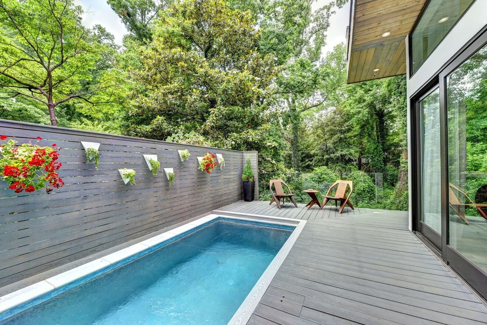 Design ideas for a mid-sized modern side yard rectangular lap pool in Atlanta with decking.