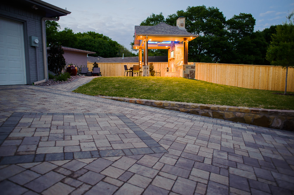 Mid-sized traditional backyard patio in Dallas with an outdoor kitchen, natural stone pavers and no cover.