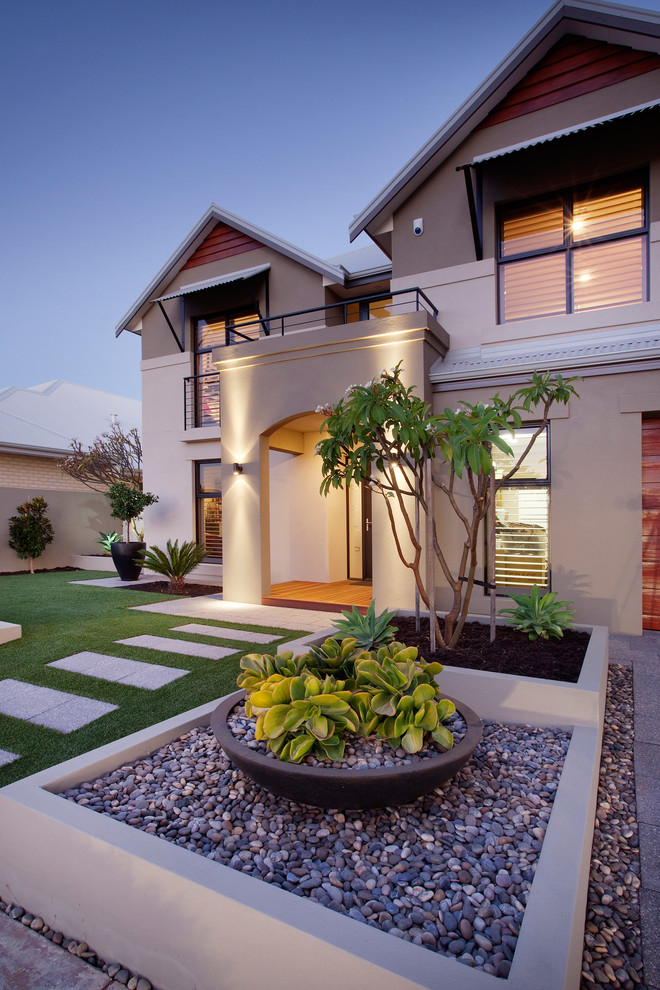This is an example of a mid-sized contemporary front yard full sun garden for summer in Perth with concrete pavers.
