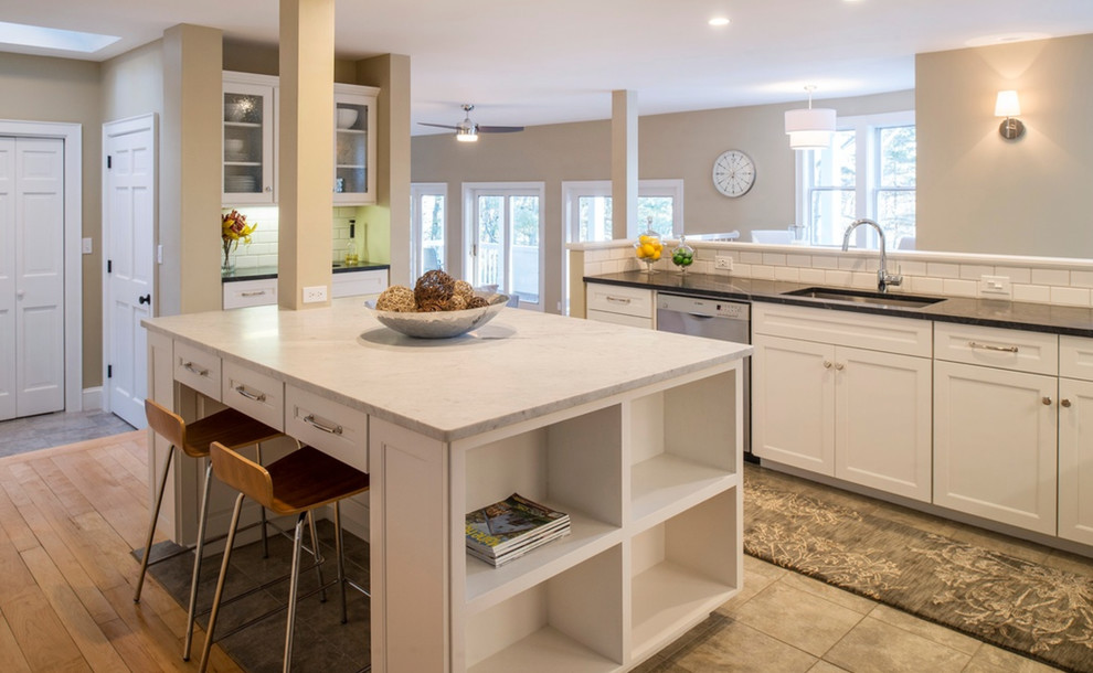Design ideas for a large contemporary kitchen in Portland Maine with an undermount sink, shaker cabinets, white cabinets, marble benchtops, white splashback, subway tile splashback, stainless steel appliances, ceramic floors and with island.