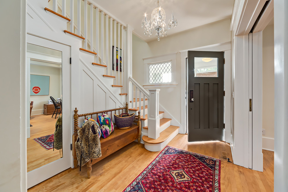 Photo of a traditional foyer in Calgary with white walls, medium hardwood floors, a single front door and a gray front door.