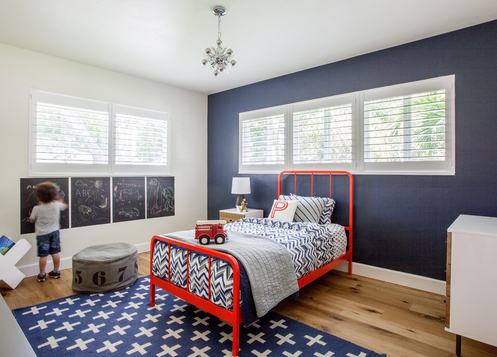 Inspiration for a transitional kids' bedroom for boys in Miami with medium hardwood floors and multi-coloured walls.