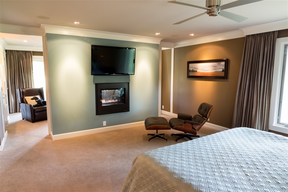 Design ideas for a mid-sized transitional master bedroom in Wichita with carpet, a two-sided fireplace, beige walls and a plaster fireplace surround.
