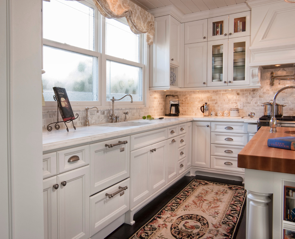 Design ideas for a traditional kitchen in San Diego with a double-bowl sink, glass-front cabinets, white cabinets, multi-coloured splashback, stainless steel appliances, dark hardwood floors and with island.