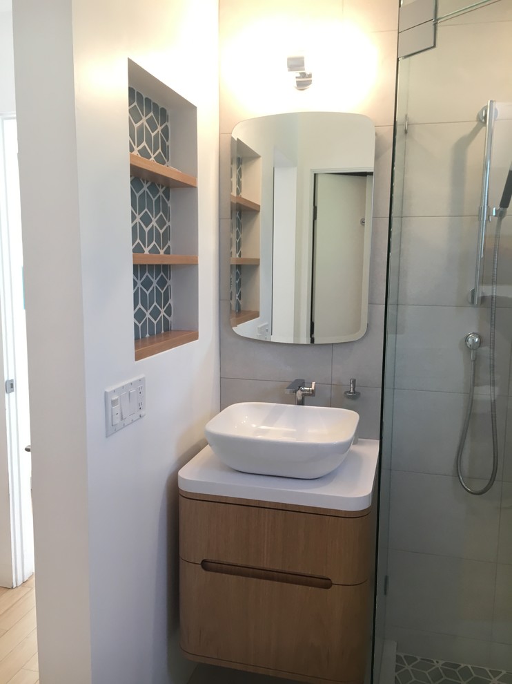 Small contemporary master bathroom in Santa Barbara with furniture-like cabinets, light wood cabinets, a corner shower, white tile, porcelain tile, white walls, porcelain floors, a vessel sink, quartzite benchtops, white floor and a hinged shower door.