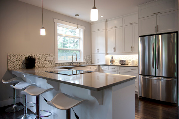 Inspiration for a dark wood floor kitchen remodel with a double-bowl sink, recessed-panel cabinets, white cabinets, multicolored backsplash, ceramic backsplash, black appliances and an island