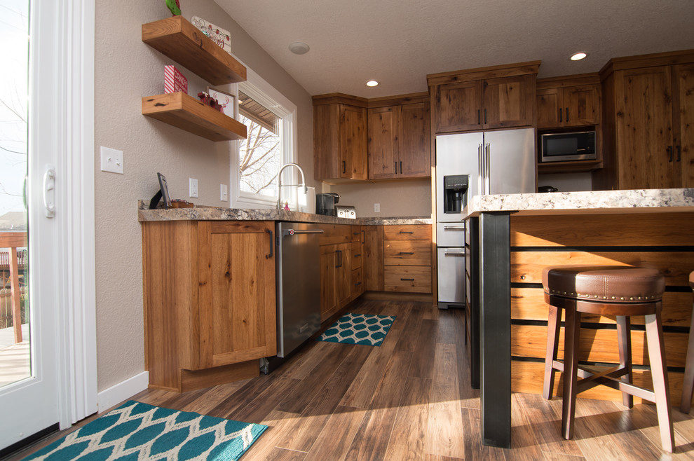 Inspiration for a mid-sized rustic l-shaped medium tone wood floor and brown floor eat-in kitchen remodel in Denver with an undermount sink, shaker cabinets, medium tone wood cabinets, quartz countertops, black appliances, an island and multicolored countertops