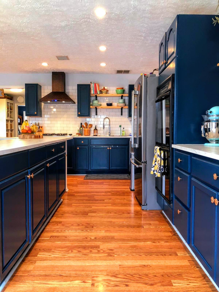 Inspiration for an expansive eclectic l-shaped eat-in kitchen in Atlanta with white splashback, subway tile splashback, with island and white benchtop.
