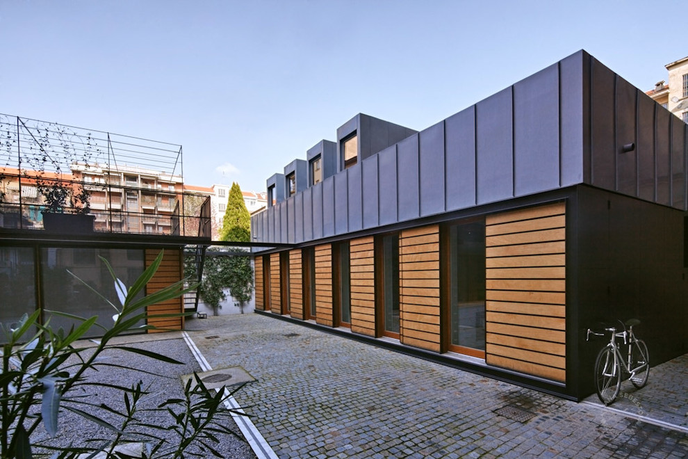 Inspiration for a contemporary one-storey exterior in Turin with mixed siding.
