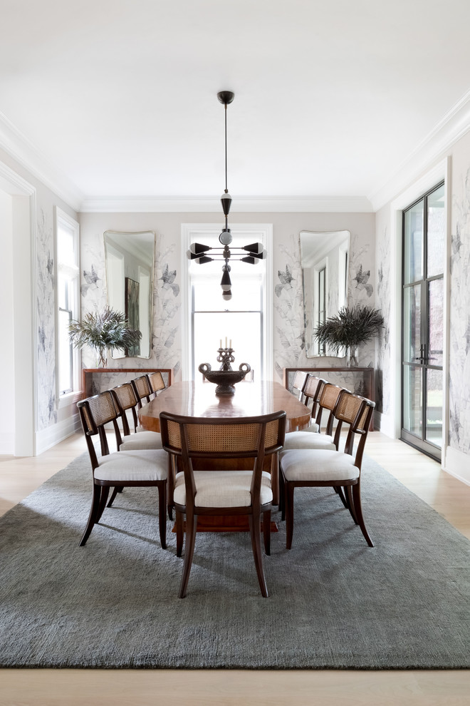 This is an example of a large transitional separate dining room in Austin with light hardwood floors and brown floor.