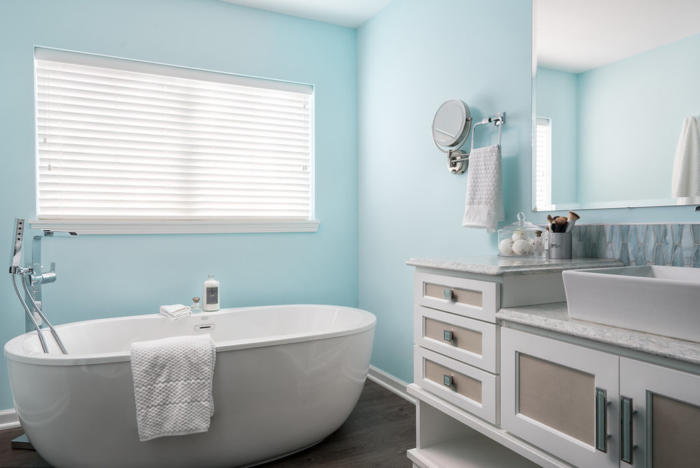 Inspiration for a large contemporary master bathroom in Columbus with recessed-panel cabinets, white cabinets, a freestanding tub, an alcove shower, a one-piece toilet, blue tile, ceramic tile, grey walls, vinyl floors, a vessel sink, engineered quartz benchtops, grey floor and a hinged shower door.