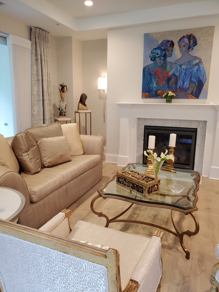 This is an example of a mid-sized transitional open concept living room in DC Metro with a music area, beige walls, a standard fireplace, a stone fireplace surround, beige floor and recessed.
