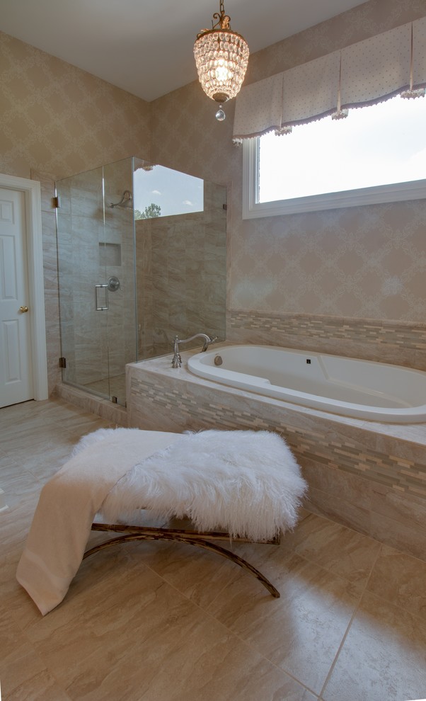 Design ideas for a large contemporary master bathroom in Charlotte with beige walls, limestone floors, beige floor, a drop-in tub, an alcove shower, beige tile, limestone, an undermount sink, laminate benchtops, a hinged shower door, recessed-panel cabinets and beige cabinets.