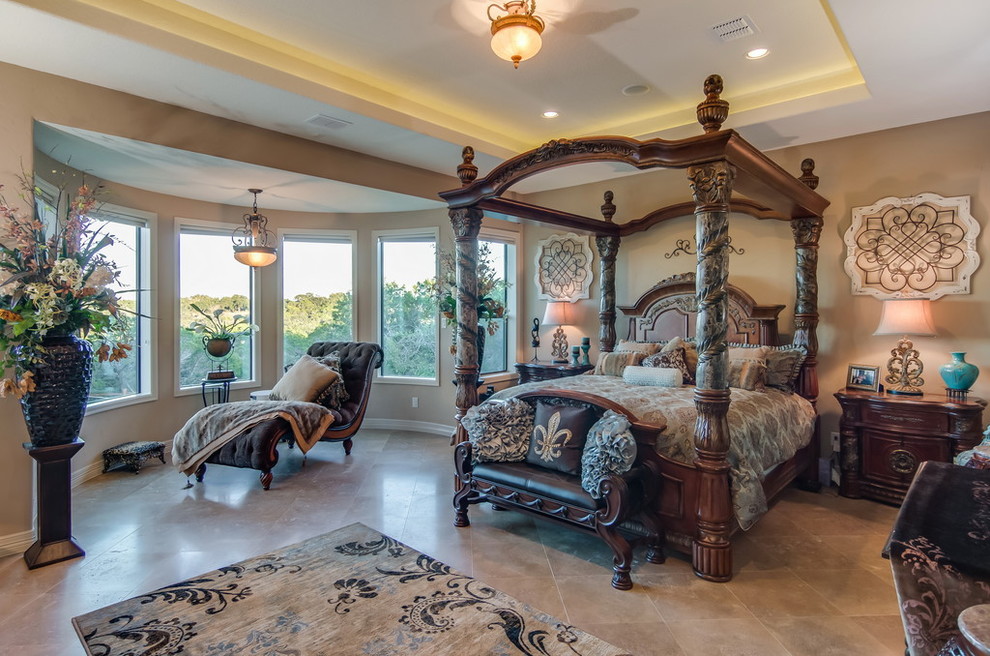 Inspiration for a large mediterranean master bedroom in Austin with beige walls and ceramic floors.