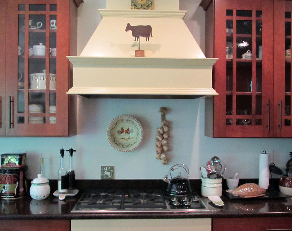 Inspiration for a mid-sized craftsman l-shaped medium tone wood floor eat-in kitchen remodel in DC Metro with an undermount sink, granite countertops, black appliances, white walls and an island