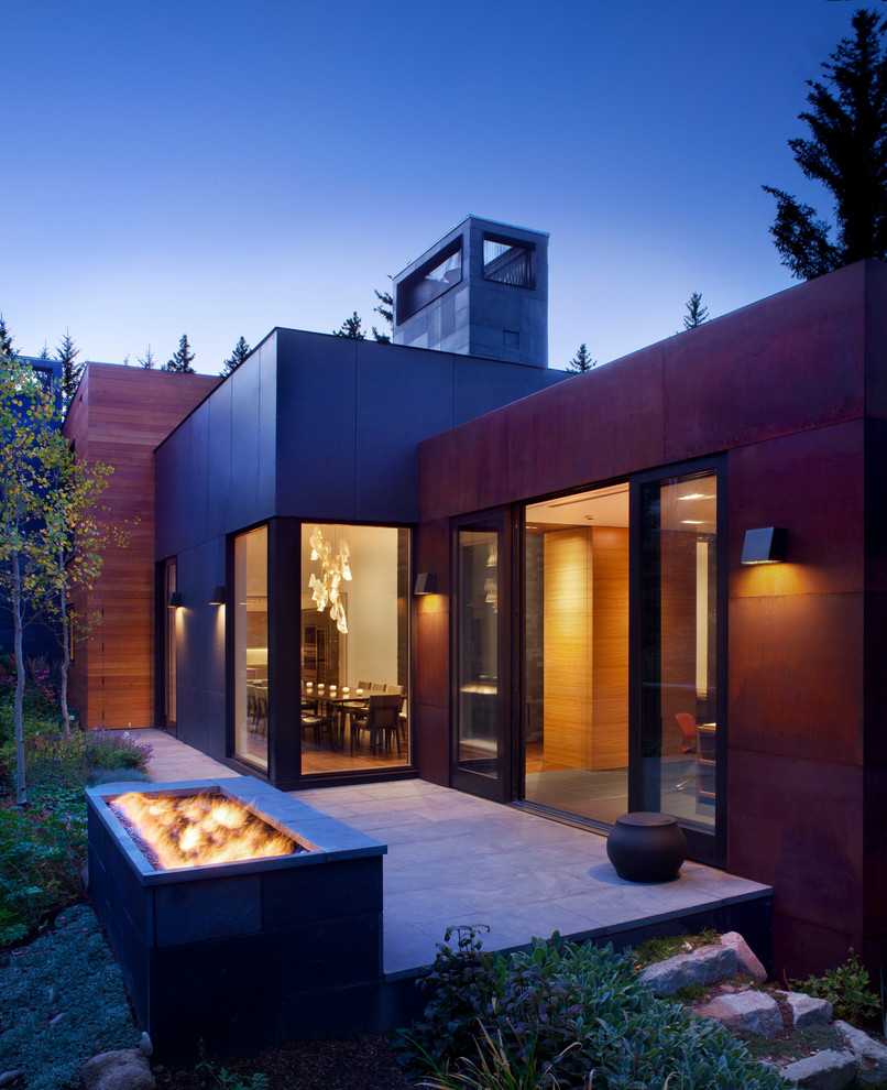 This is an example of a mid-sized contemporary backyard garden in Denver with a fire feature and concrete pavers.