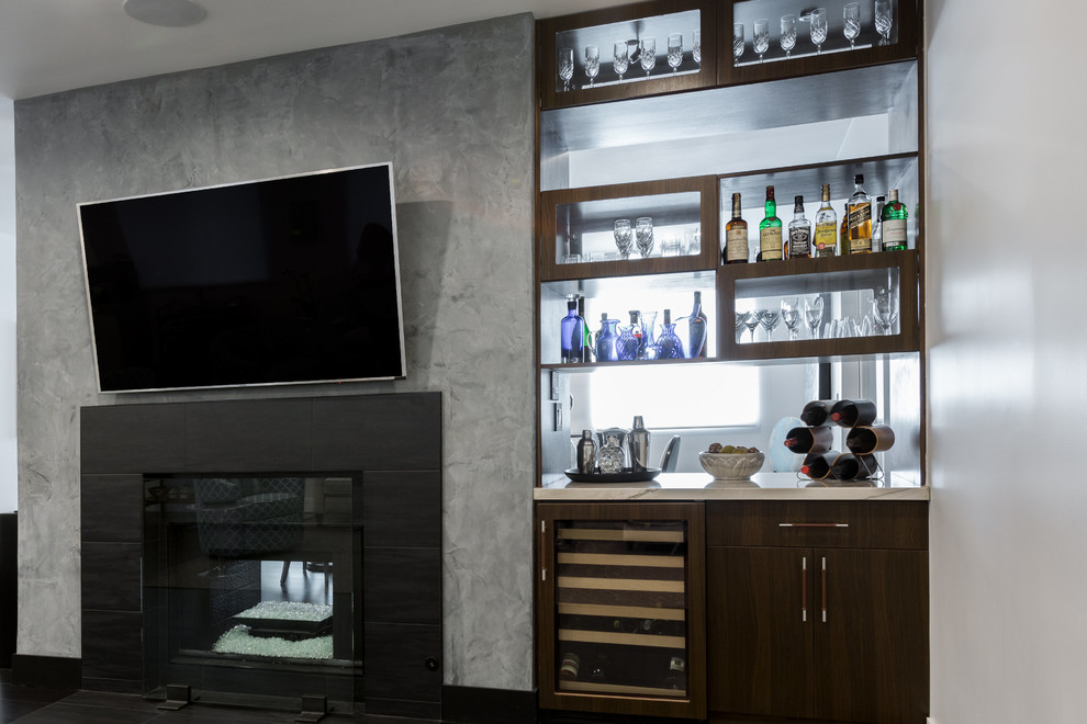 Inspiration for a small transitional single-wall home bar in Los Angeles with flat-panel cabinets, dark wood cabinets and dark hardwood floors.