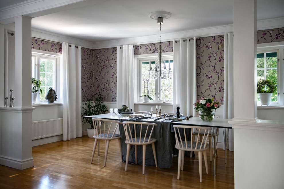 This is an example of a mid-sized transitional separate dining room in Stockholm with medium hardwood floors, brown floor and purple walls.