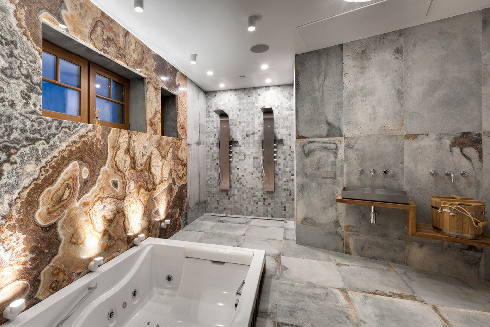 Inspiration for an expansive contemporary bathroom with a hot tub, multi-coloured tile, stone slab, multi-coloured walls, porcelain floors, grey floor, an open shower, a double shower, a vessel sink, wood benchtops and brown benchtops.
