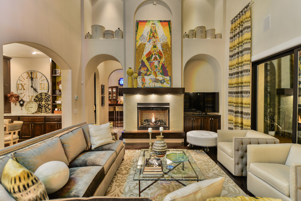 Inspiration for a mid-sized eclectic open concept family room in Austin with concrete floors, a standard fireplace, a tile fireplace surround and a built-in media wall.