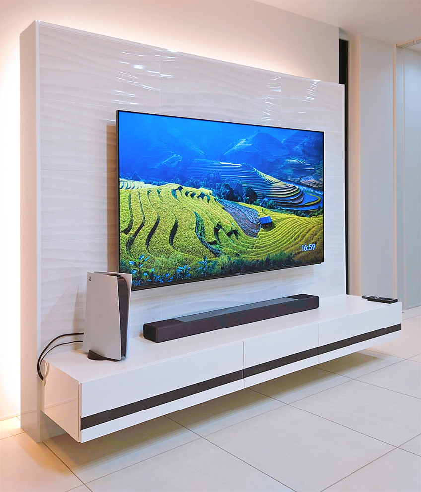 Photo of a modern living room in Other with a wall-mounted tv.