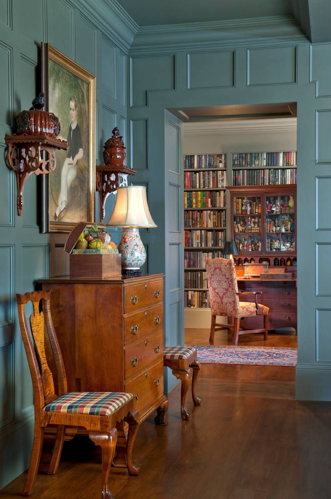 This is an example of a traditional hallway in Boston with medium hardwood floors and blue walls.