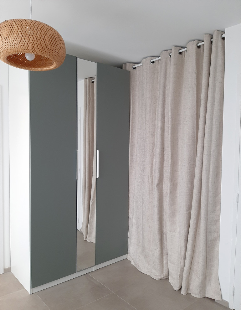 Ejemplo de armario vestidor unisex minimalista de tamaño medio con armarios con paneles lisos, puertas de armario verdes, suelo de baldosas de cerámica y suelo gris