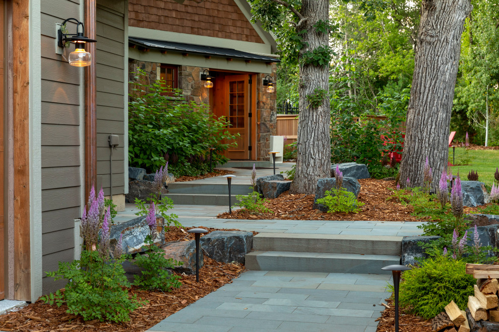 Photo of a mid-sized country backyard garden for summer in Minneapolis with natural stone pavers.