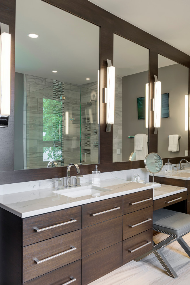 Design ideas for a large contemporary master bathroom in Minneapolis with an undermount sink, flat-panel cabinets, dark wood cabinets, marble benchtops, a freestanding tub, an alcove shower, white tile, grey walls, porcelain floors and stone tile.