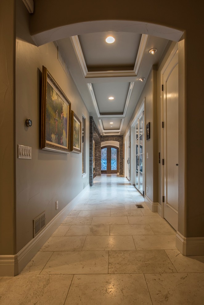 This is an example of a mid-sized mediterranean hallway in Denver with beige walls and ceramic floors.