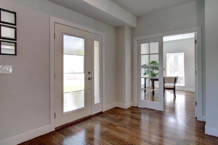 Inspiration for a mid-sized contemporary front door in Denver with white walls, medium hardwood floors, a single front door and a white front door.