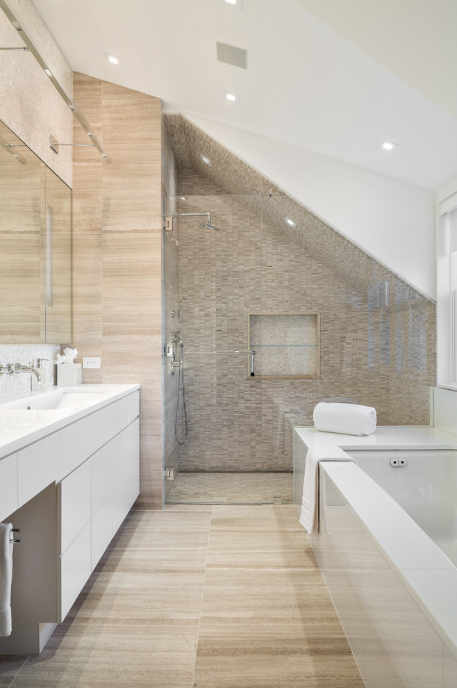 This is an example of a contemporary bathroom in New York with flat-panel cabinets, white cabinets, an undermount tub, an alcove shower, gray tile and an undermount sink.
