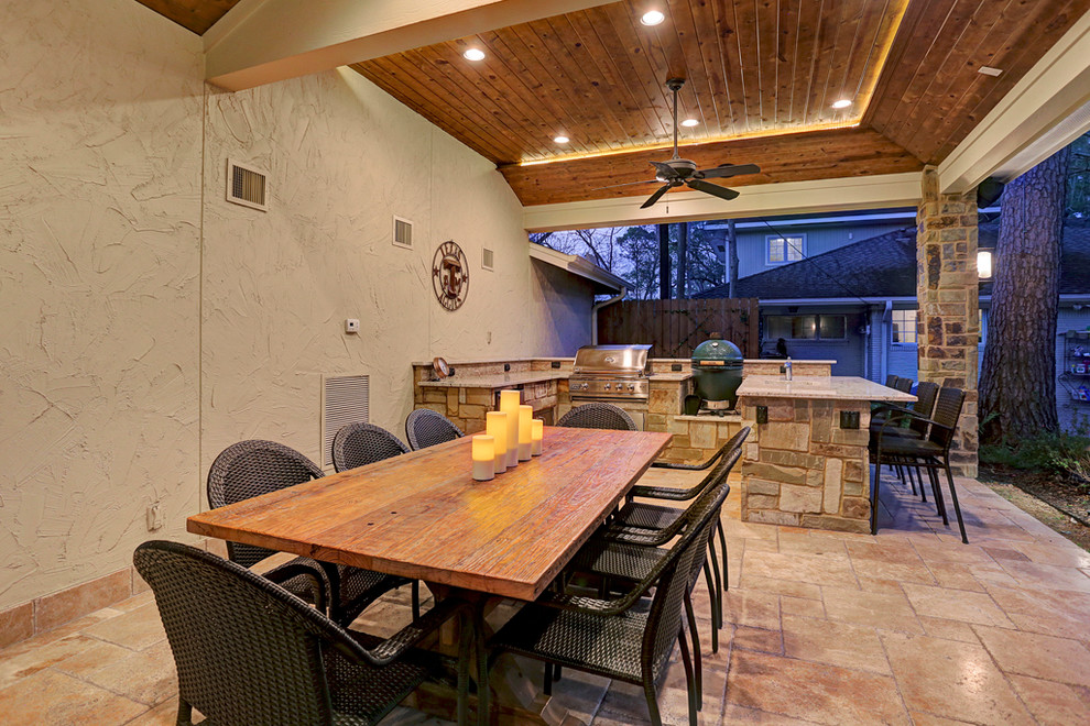 Mid-sized country backyard patio in Houston with an outdoor kitchen, tile and a roof extension.
