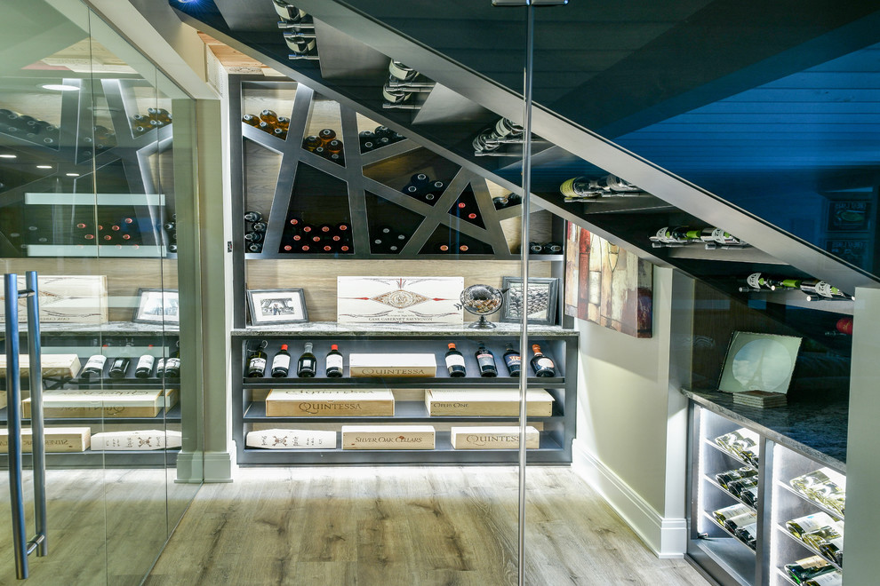 Photo of a mid-sized contemporary wine cellar in Cleveland with vinyl floors, display racks and beige floor.