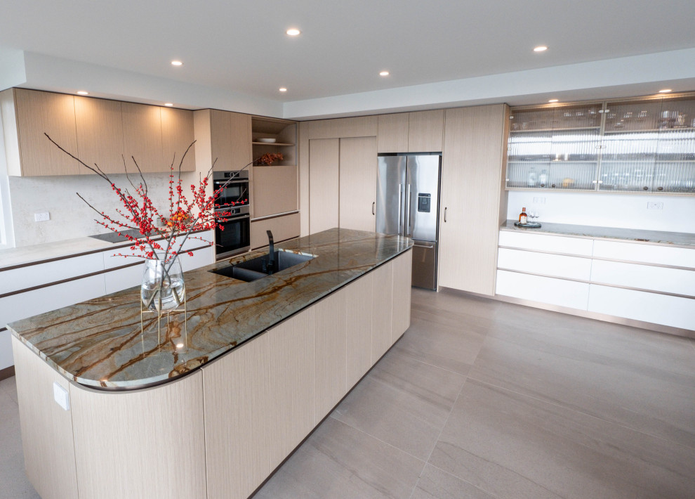 Photo of a contemporary kitchen in Auckland with light wood cabinets, quartzite benchtops, ceramic floors, with island, beige floor and multi-coloured benchtop.