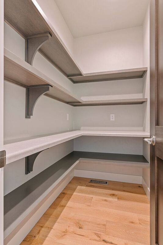 Kitchen pantry - transitional l-shaped light wood floor kitchen pantry idea with shaker cabinets, gray cabinets, quartz countertops, white backsplash, mosaic tile backsplash, stainless steel appliances and white countertops