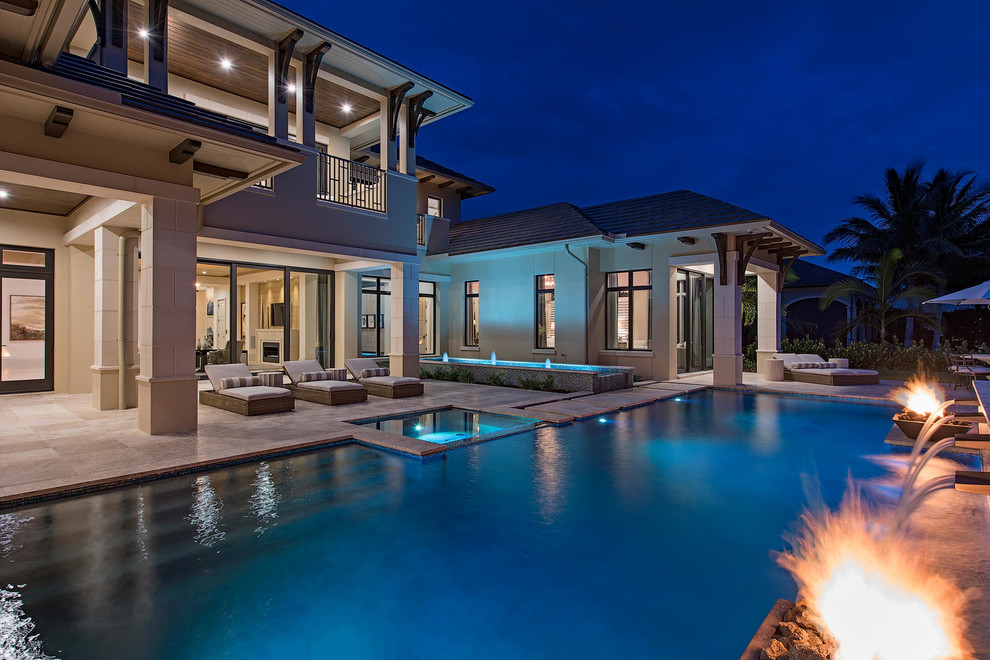 Inspiration for an expansive transitional backyard rectangular pool in Miami with a water feature.