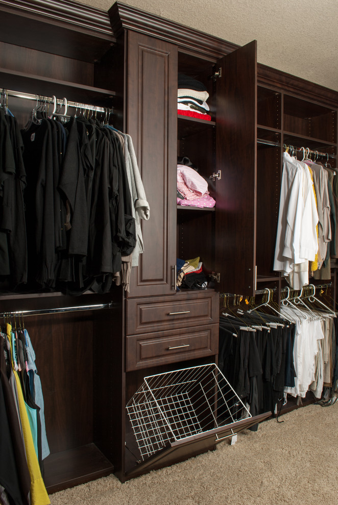Mid-sized traditional men's walk-in wardrobe in Miami with raised-panel cabinets, dark wood cabinets and carpet.