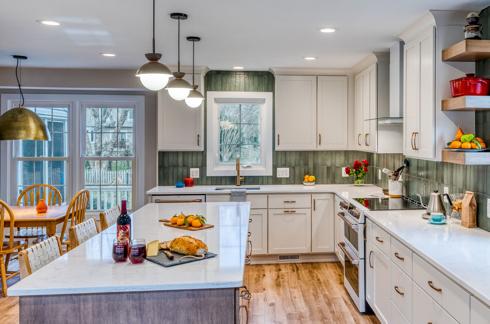 Example of a large transitional kitchen design in DC Metro with flat-panel cabinets, white cabinets, quartz countertops, green backsplash, ceramic backsplash, an island and white countertops