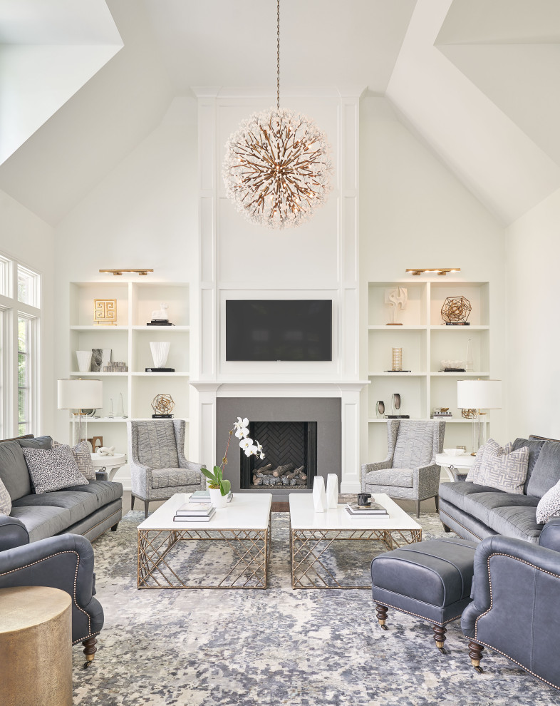 Inspiration for an expansive transitional formal open concept living room in Detroit with white walls, medium hardwood floors, a standard fireplace, a tile fireplace surround, a wall-mounted tv and brown floor.